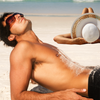 Summer sun and skincare maintenance - picture of couple lying on beach tanning